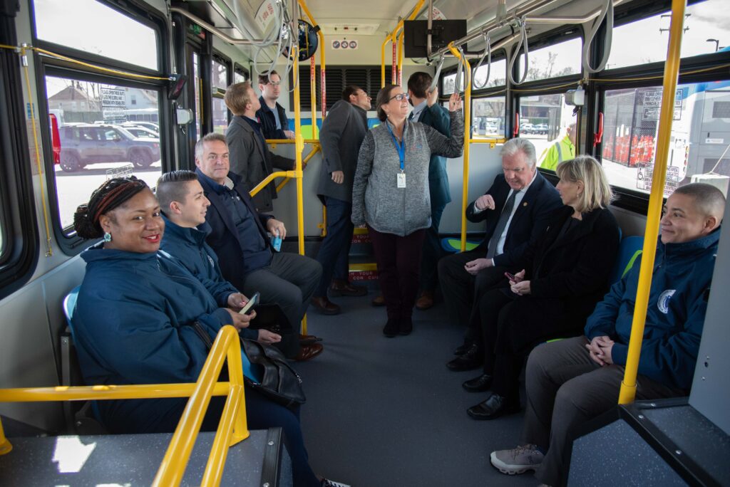Attendees get bus on for a bus ride
