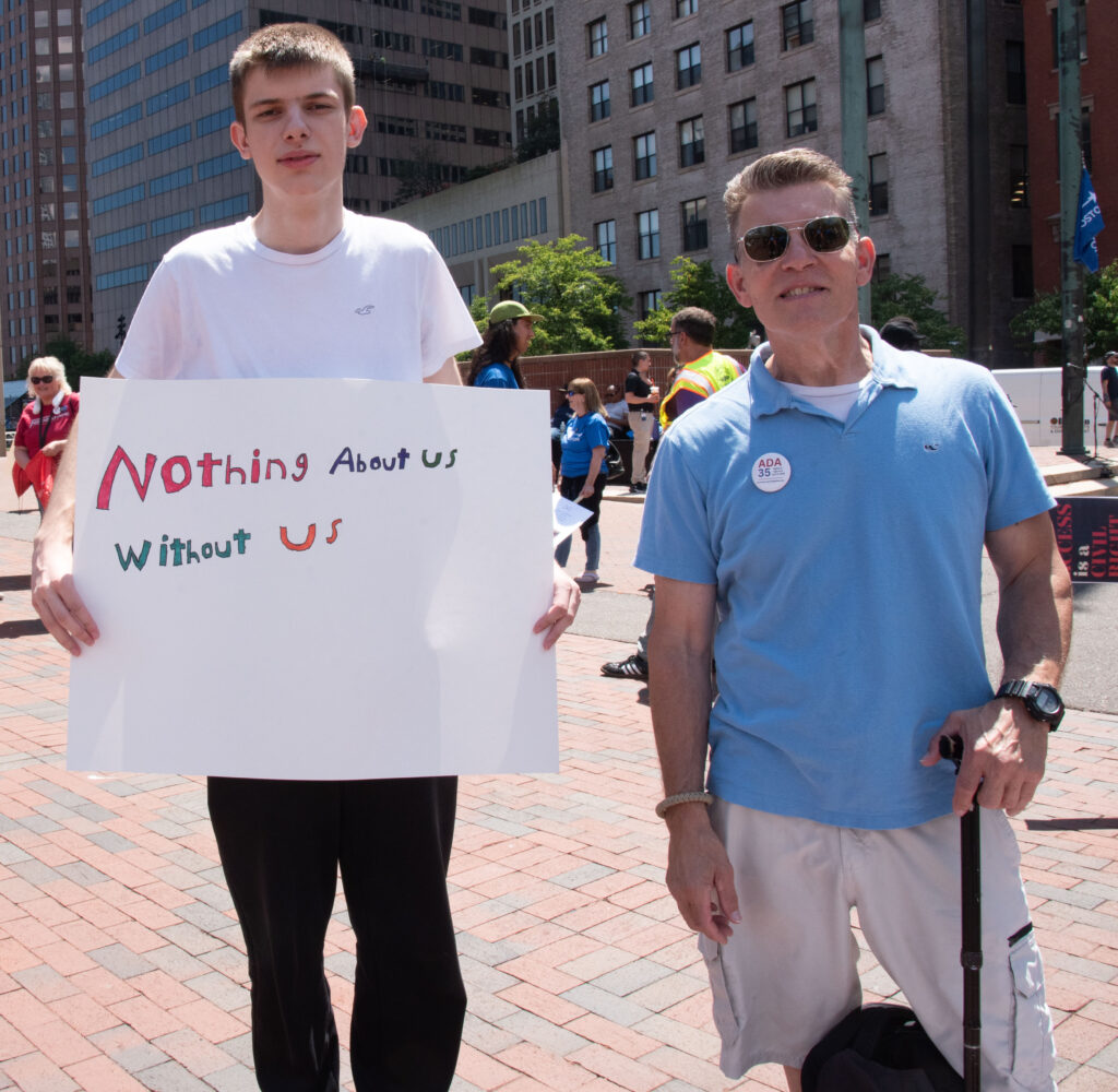 Ayman and Lou (MWCIL) - Sign "Nothing about us without us"